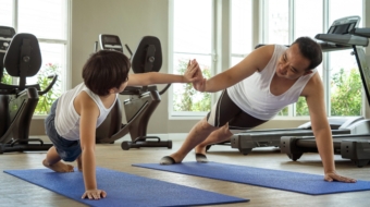 Asian,Father,And,His,Eight-year-old,Son,Exercise,Together,,Stretching,,Strengthening,